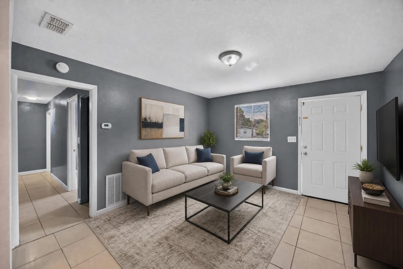 Living room virtually staged with sofa and TV at 6745 Jack Horner Ln, Jacksonville, FL 32210