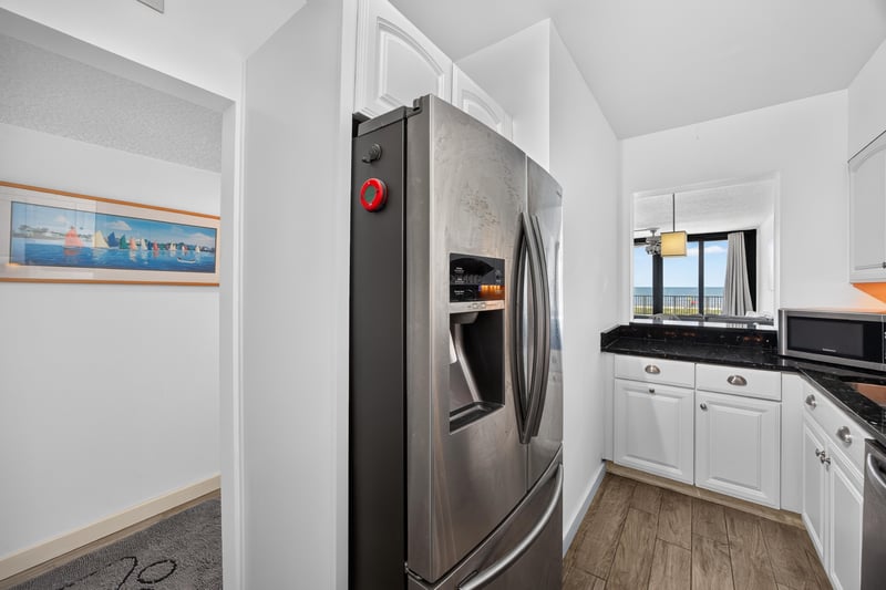 Kitchen stainless refrigerator and cabinets at 601 1st St S, Jacksonville Beach