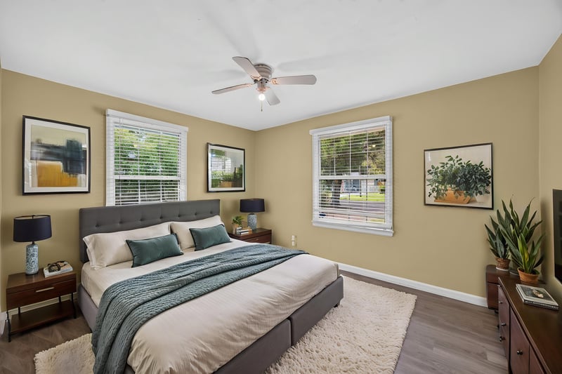 Bedroom with staged bed, wood-look floors and ceiling fan at 2841 Ernest St, Jacksonville, FL 32205