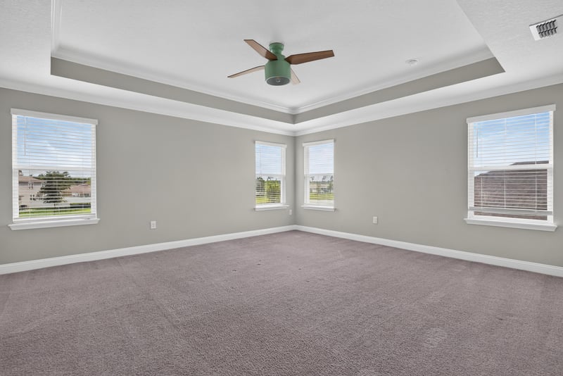 Bedroom with tray ceiling and carpet at 2580 Cold Stream Ln, Green Cove Springs, FL 32043
