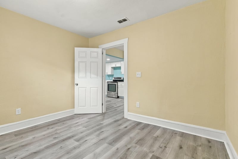 Empty room toward kitchen doorway, photographed by Megapixeler on W 24th St, Jacksonville