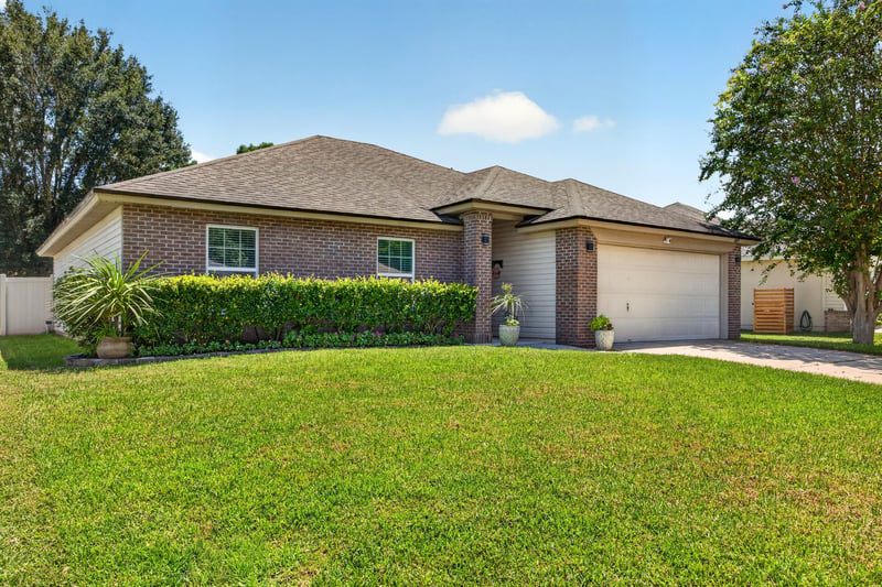 Front exterior with brick accents at 1589 Backwater Drive, Middleburg, FL 32068
