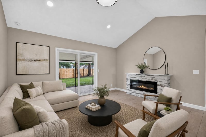 Living room with fireplace and virtually staged sectional at 4117 Wilcrest Ct, Jacksonville, FL 32277