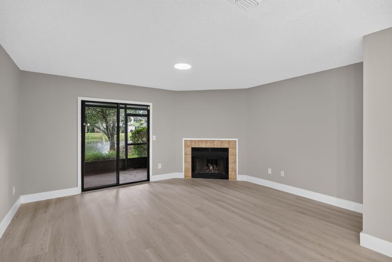 Living room corner with fireplace and window at 3801 Crown Point Rd, Jacksonville, FL 32257