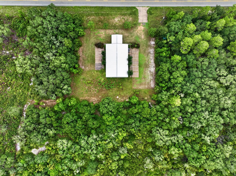 Drone aerial straight down of the building and gravel drive at 1038 County Rd 315, Melrose