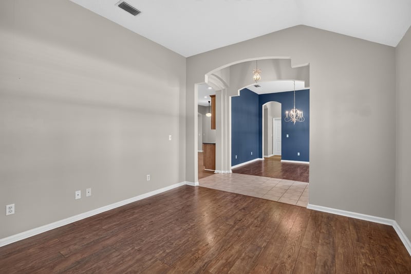 Hallway with arched opening to adjoining room at 1955 GUARDED Way, Fleming Island, FL 32003