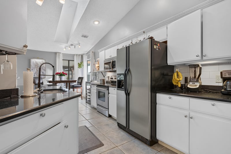 Kitchen with vaulted ceiling and stainless refrigerator at 13020 Medford Ln, Jacksonville, FL 32225