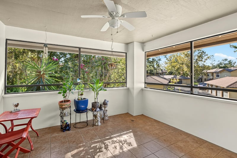 Sunroom with windows and small table at 10150 Belle Rive Blvd, Jacksonville, FL
