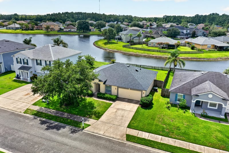 Aerial view of the home with pond in background at 2065 Creekmont Dr