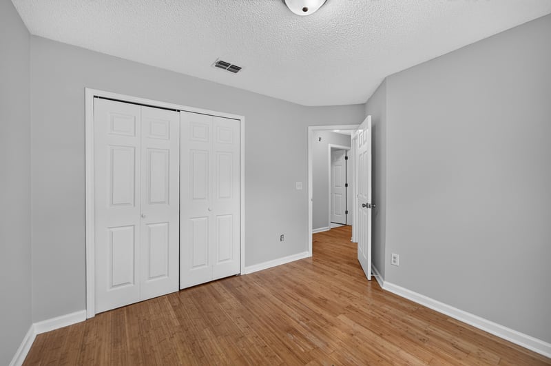 Bedroom with double closet and wood floors at 456 Bay Point Way N, Jacksonville, FL 32259