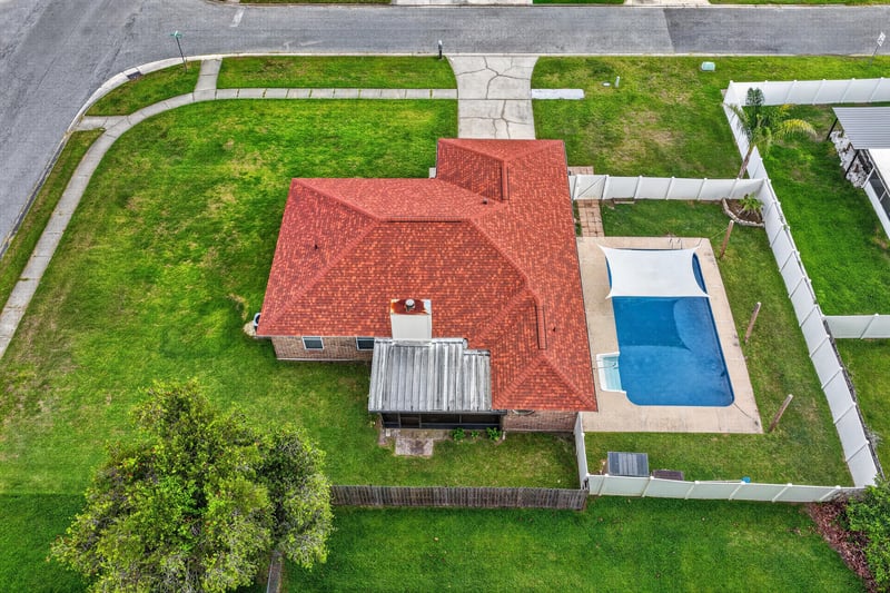 Aerial view of backyard pool and screened porch at 2164 Orangewood St, Middleburg, FL 32068