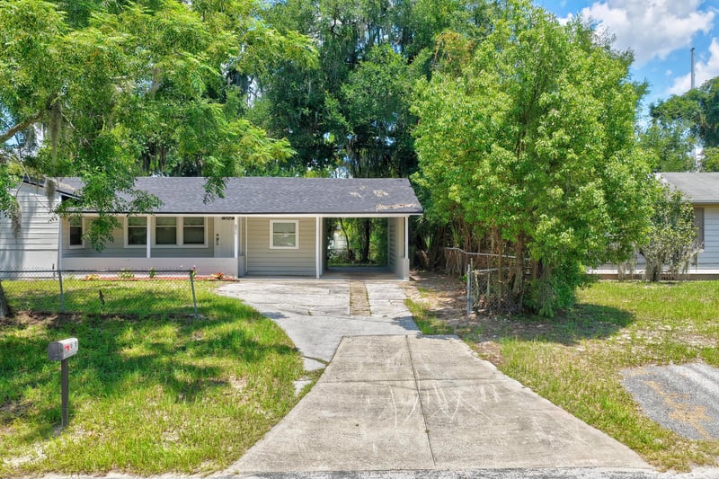 Front exterior with curved driveway and landscaping at 855 Cornwallis Dr, Jacksonville, FL