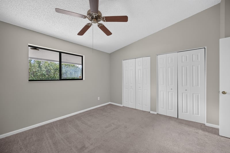 Bedroom with double closets and ceiling fan at 3801 Crown Point Rd, Jacksonville, FL 32257