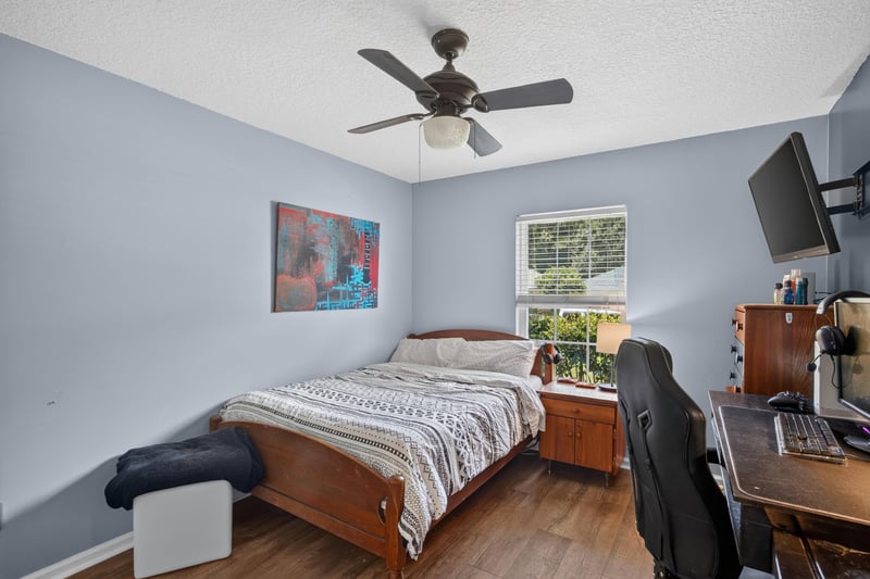 Bedroom with desk and wall-mounted tv at 1589 Backwater Drive, Middleburg, FL 32068