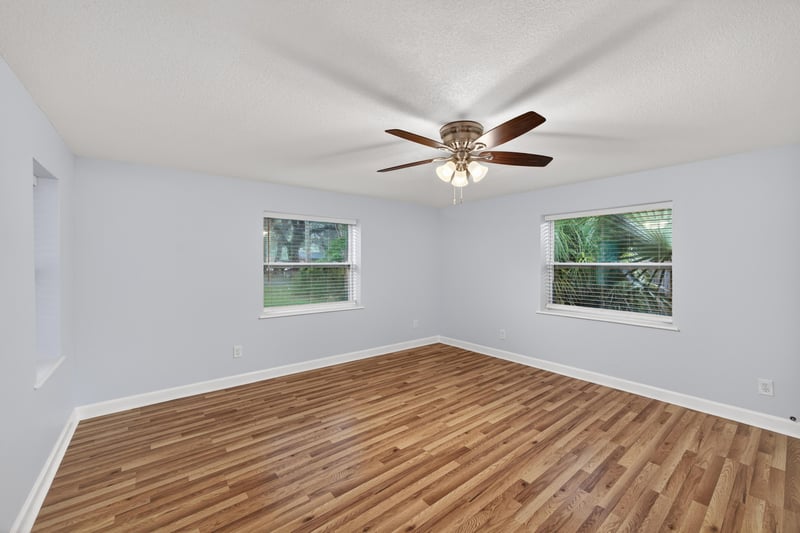 Empty room with wood floors and two windows at 1619 Hammond Blvd, Jacksonville, FL