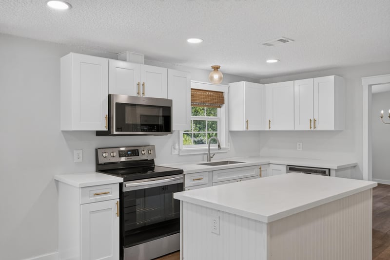 Kitchen with stainless appliances and white cabinets at 4890 McAllister Rd, Middleburg, FL 32068