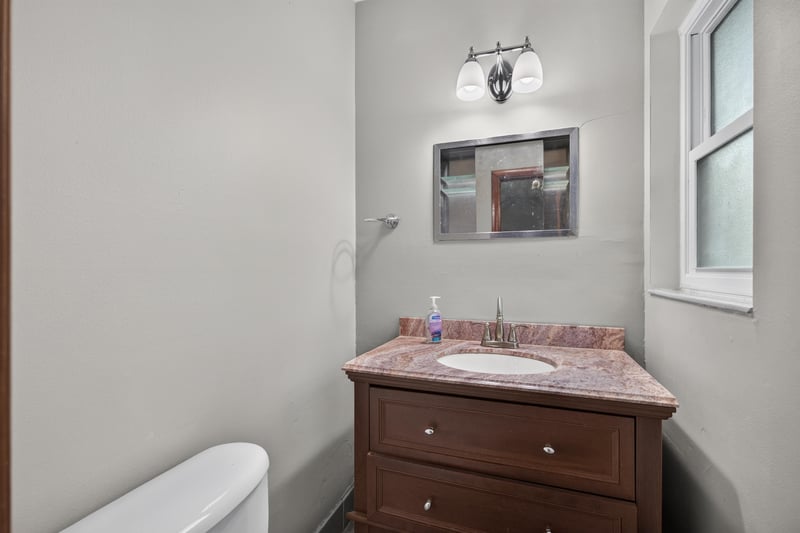 Bathroom with dark wood vanity and mirror at 11462 Elane Dr, Jacksonville, FL