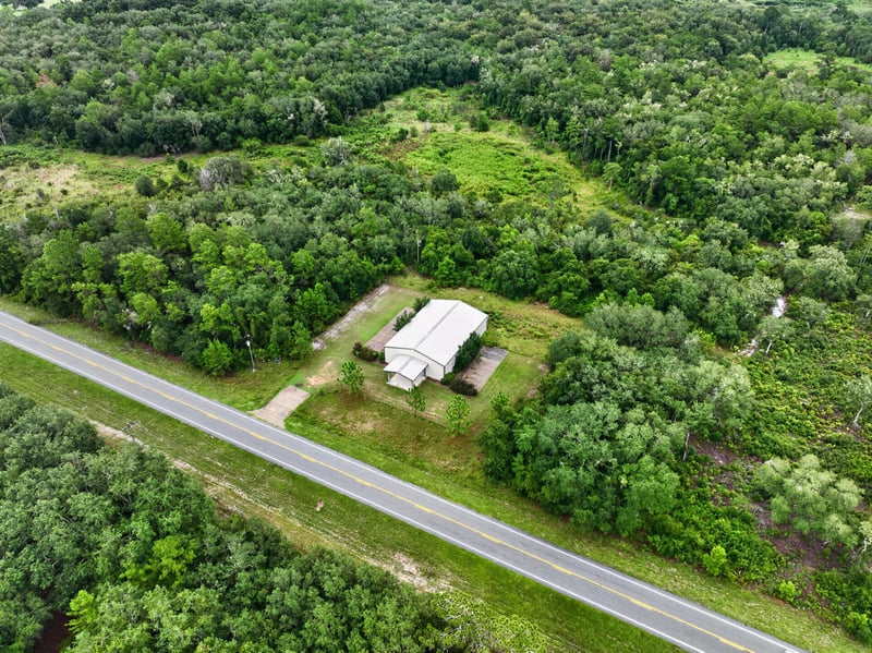 Drone aerial of the building along the county road at 1038 County Rd 315, Melrose