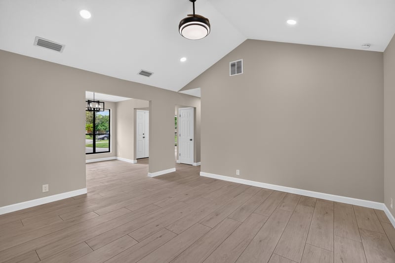 Empty open living and dining area with wood-look flooring at 4117 Wilcrest Ct, Jacksonville, FL 32277
