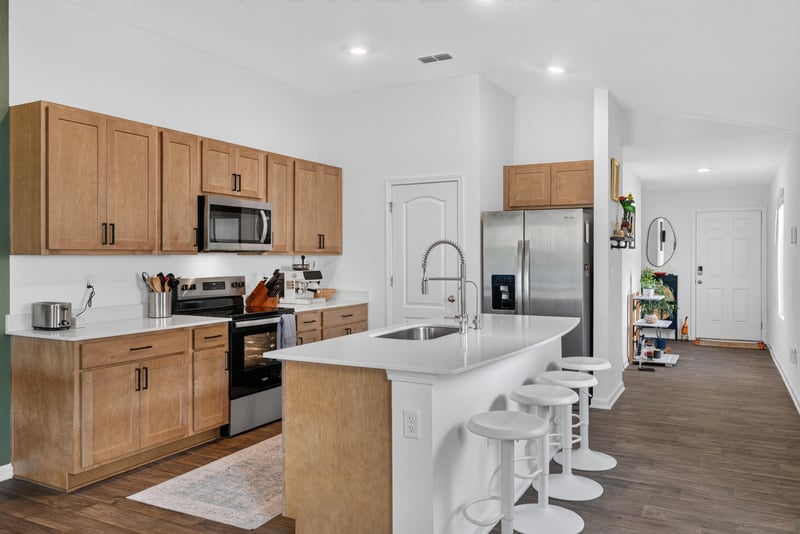 Kitchen with wood cabinets and range at 4276 Quaking St, Jacksonville, FL 32218
