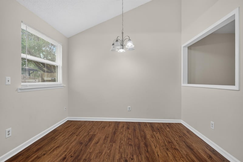 Empty room with vaulted ceiling and chandelier at 4427 Millstone Ct, Jacksonville, FL