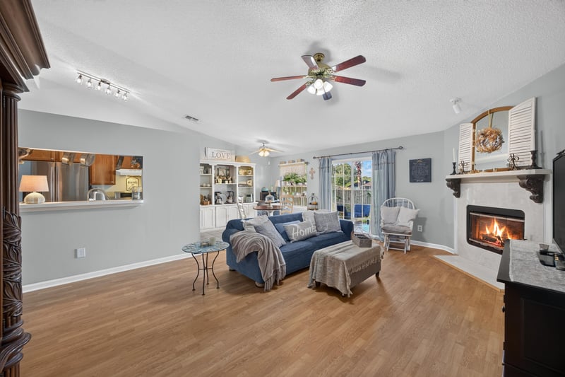 Living room with pass-through window to kitchen at 4556 Shaky Leaf Ln N, Jacksonville, FL 32224