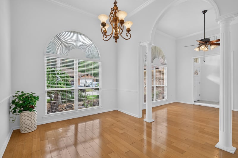 Dining space with arched windows and chandelier at 12810 Swamp Owl Ln