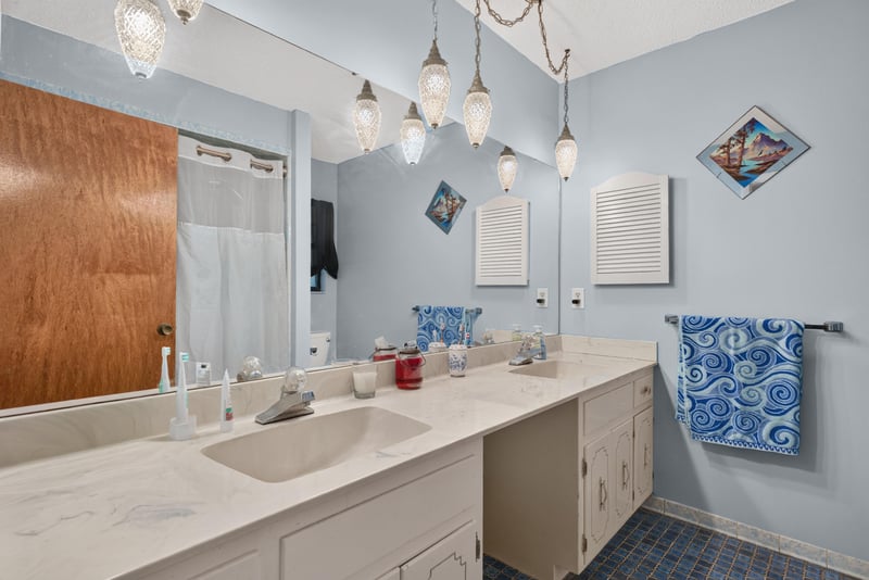 Primary bathroom with double vanity and pendant lights at 3249 Maryland Ave, Green Cove Springs, FL