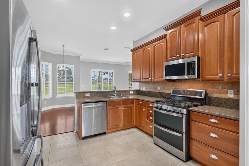 Kitchen with stainless refrigerator and bright windows at 4109 Eagle Landing Pkwy, Orange Park, FL 32065