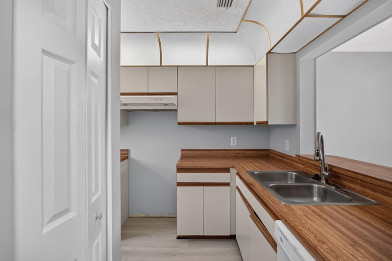 Kitchen with white cabinets and butcher block counters at 3801 Crown Point Rd, Jacksonville, FL 32257