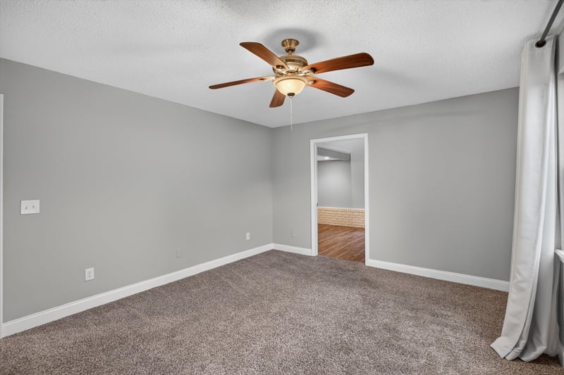 Carpeted bedroom with curtain at 12344 Cormorant Ct, Jacksonville, FL