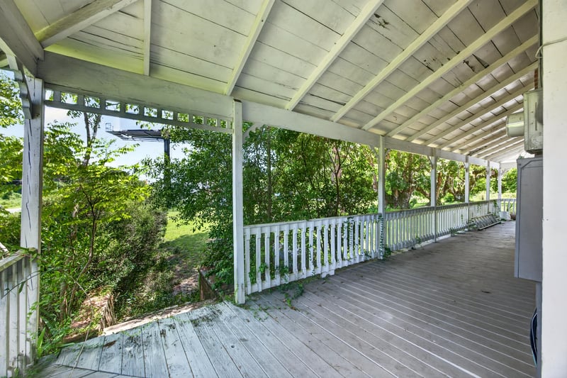 Covered porch overlooking the side yard at 1173 US-17, Satsuma, FL 32189