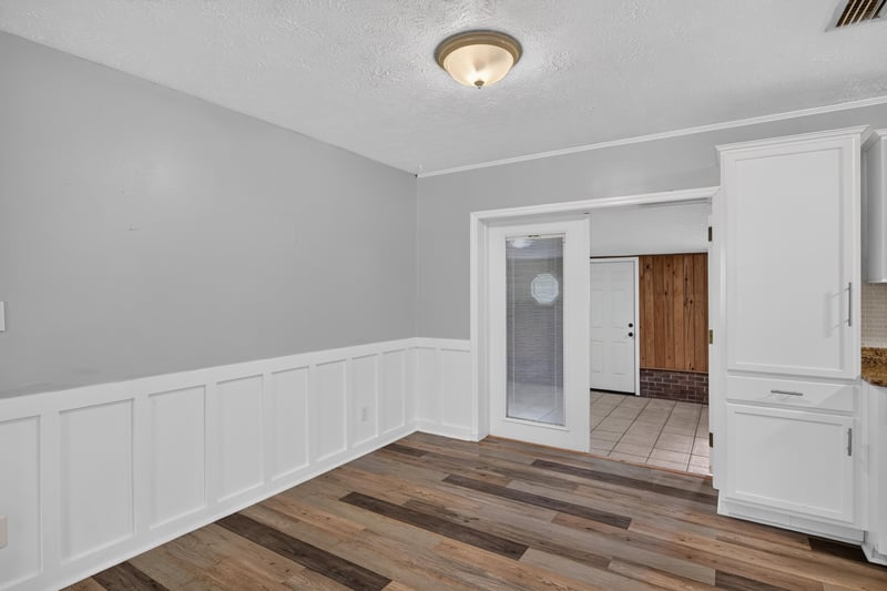 Hallway with wainscoting and wood-look flooring at 6757 Deer Springs Rd, Keystone Heights, FL 32656