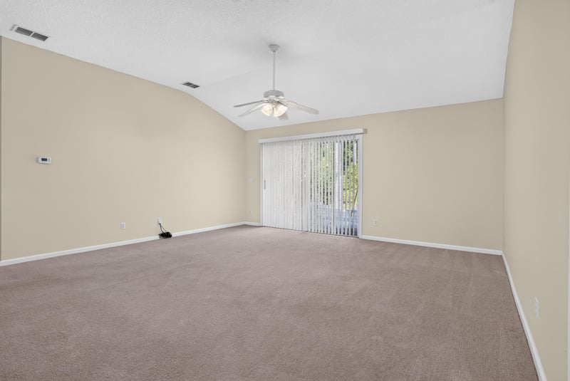 Living room with ceiling fan and sliding glass door at 299 John's Creek Pkwy, St. Augustine, FL 32092