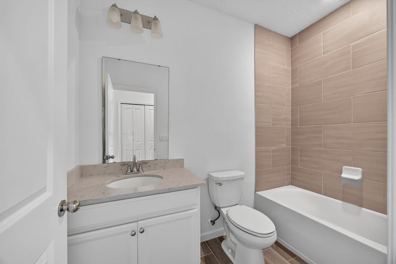 Bathroom with vanity and tub-shower combo, virtually staged at 9905 Ansley Lake Dr, Jacksonville, FL