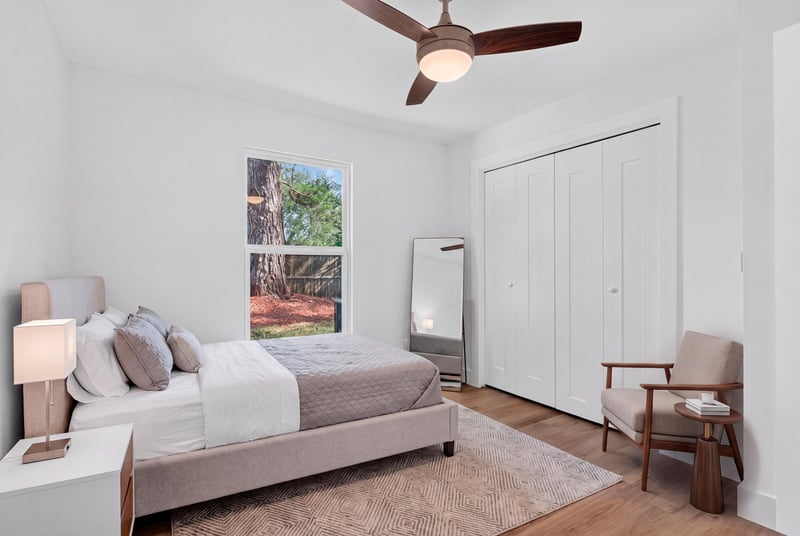 Bedroom with staged bed and closet doors at 8453 Boysenberry Ln W, Jacksonville, FL