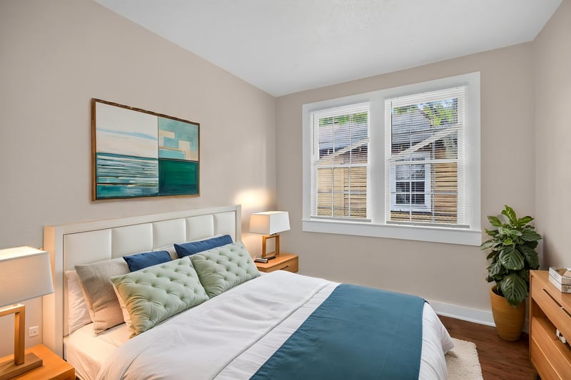 Virtually staged bedroom with bed near windows at 1473 State St W, Jacksonville, FL 32209