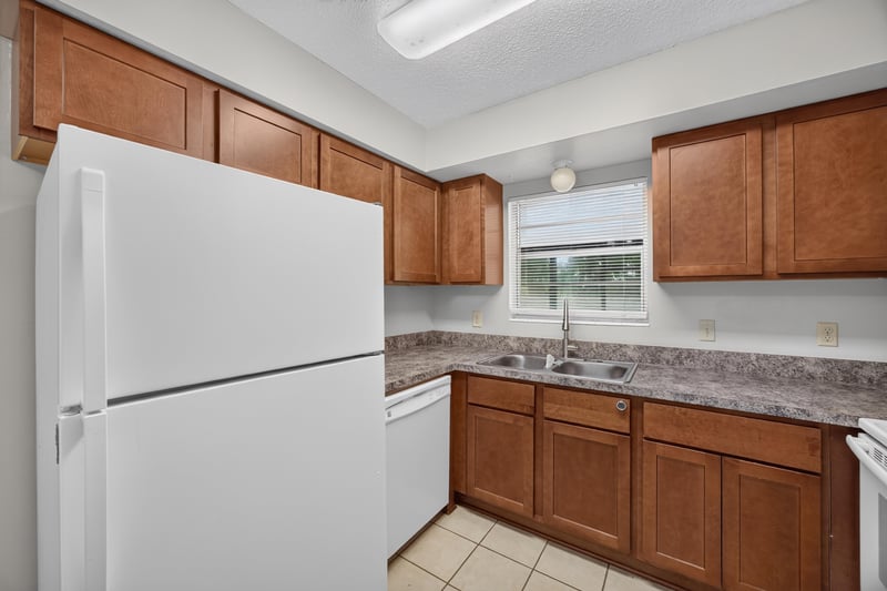 Kitchen with white refrigerator and window over sink at 12351 Condor Dr
