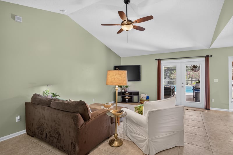 Living room with french doors to patio at 1589 Backwater Drive, Middleburg, FL 32068