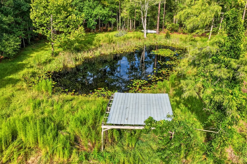 Pond with wood dock on the property at 55520 Jewel-Thomas Rd, Callahan, FL 32011