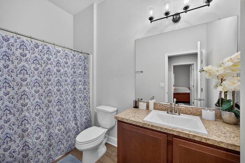 Bathroom with tub and patterned shower curtain at 9846 Olivia St, Jacksonville, FL