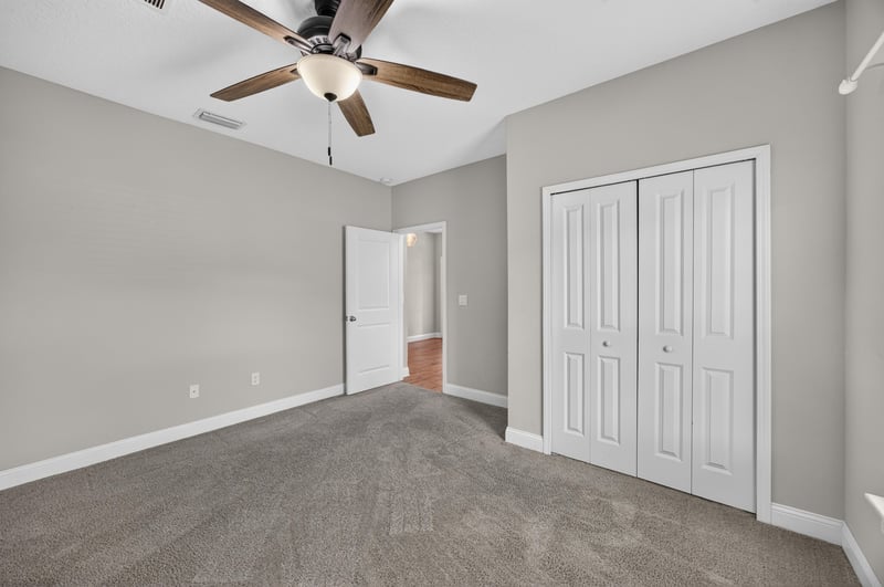 Carpeted bedroom with ceiling fan at 53 Lumen Ct, St. Augustine, FL 32095