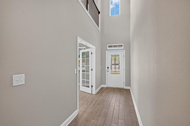Foyer hallway leading to glass front door at 2580 Cold Stream Ln, Green Cove Springs, FL 32043