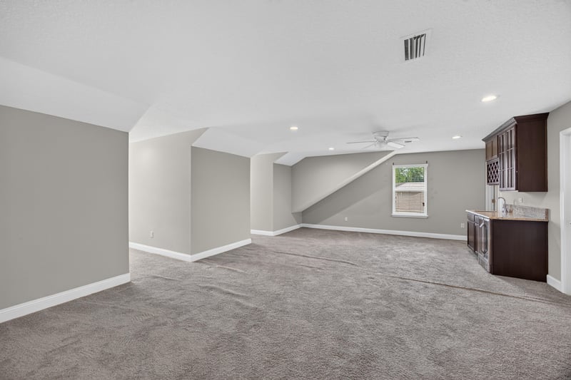 Upstairs bonus room with carpet and built-in shelving at 53 Lumen Ct, St. Augustine, FL 32095