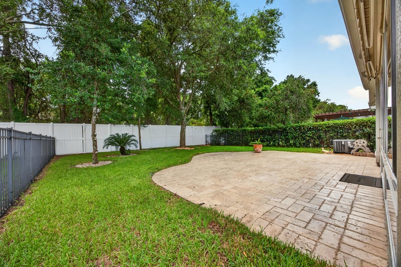 Backyard with fenced lawn and patio at 11225 Water Spring Cir, Jacksonville, FL 32256