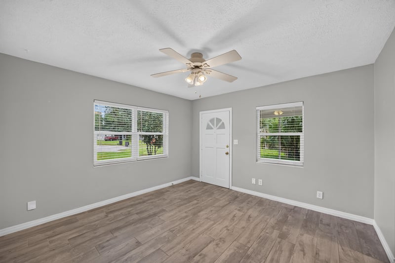 Living room, wood-look floors and two windows at 2256 Inwood Cir S, Jacksonville, FL