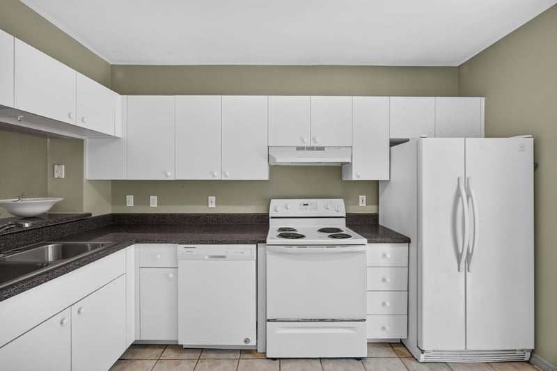 Kitchen view with white appliances and tile floor at 342 E Ashley St, Jacksonville, FL 32202