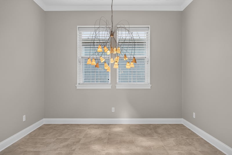 Dining area with chandelier and windows at 117 Island Cottage Way, St. Augustine, FL 32080