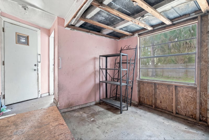 Room under renovation with window and doorway at 1807 Idlewild Ave, Green Cove Springs, FL