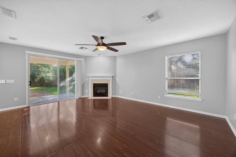 Family room with fireplace and sliding glass doors at 470 Sparrow Branch Cir, Jacksonville, FL 32259